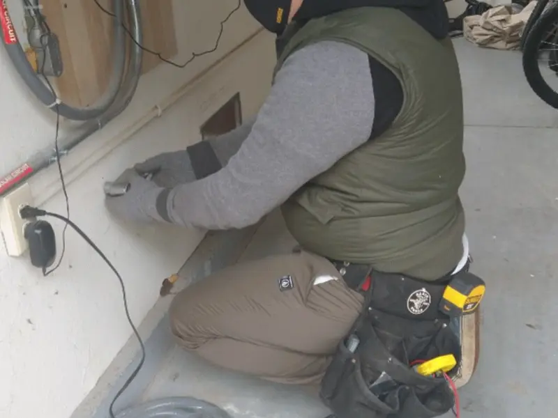 Electrician performing outlet wiring in a Chestertown garage